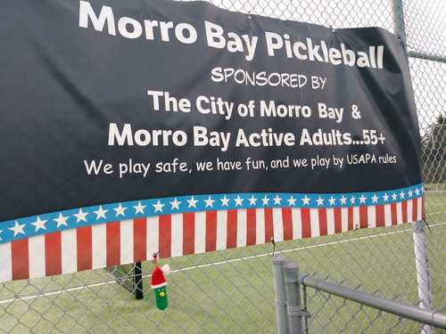 Morro Bay Pickleball banner on the court fence